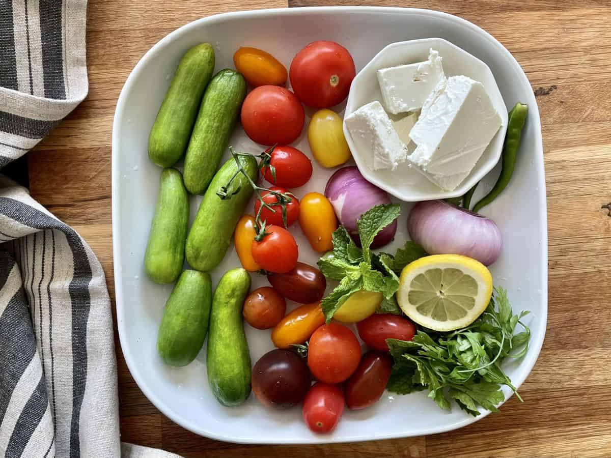 Ingredients for the summer feta salad in a platter.