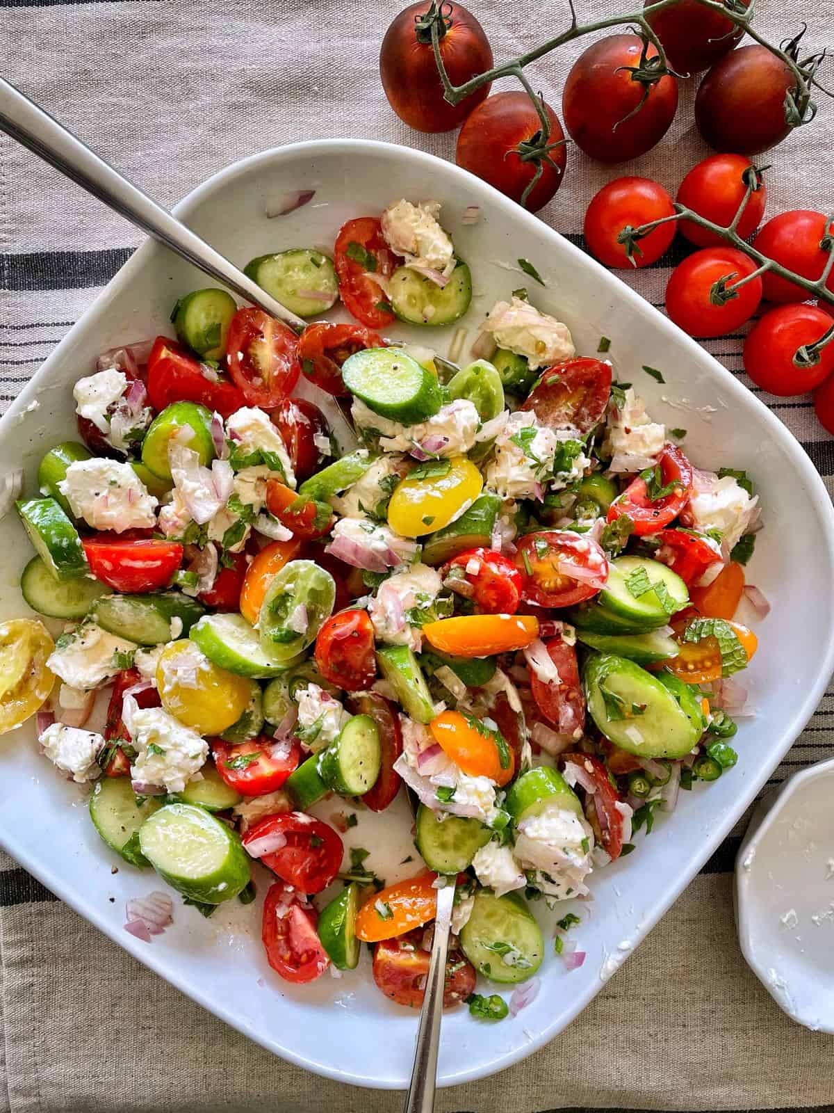 Cucumber Tomato Feta cheese Salad served in a platter.