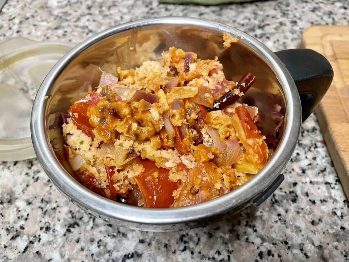 Sauteed coconut tomato chutney ingredients in a mini blender