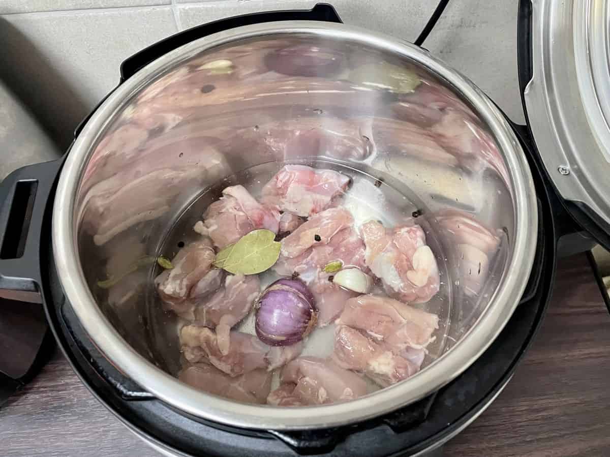 Instant pot with chicken broth ingredients.