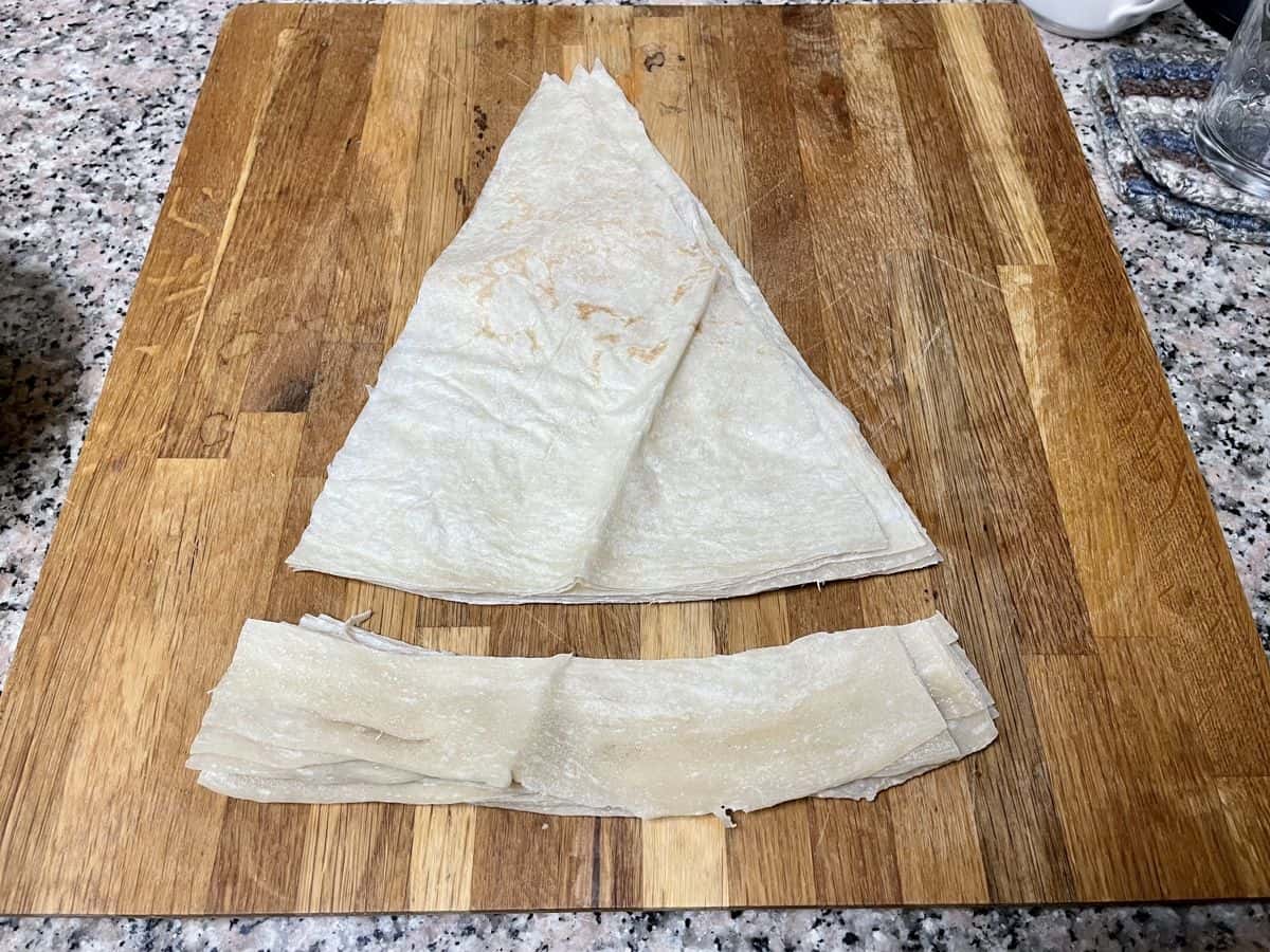 Triangle pieces cut from round flatbread with edges trimmed.