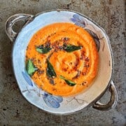 A bowl of coconut tomato chutney with freshly tempered with tadka.