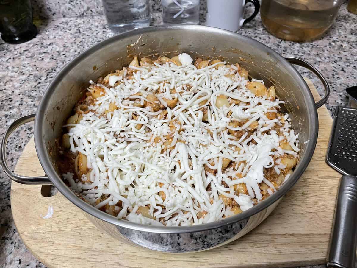 The pan is topped with grated cheese.