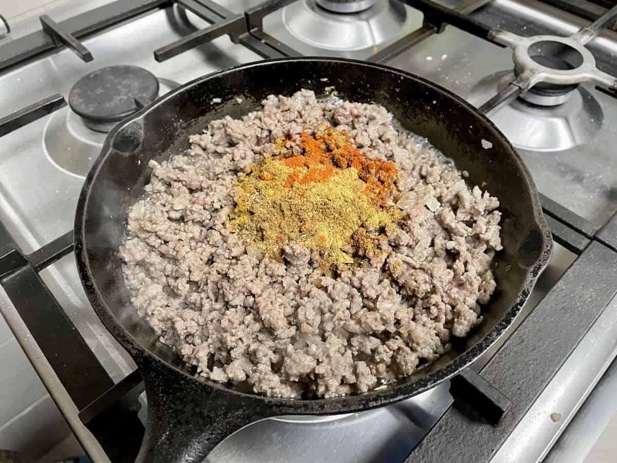 Ground spices over browned ground meat.