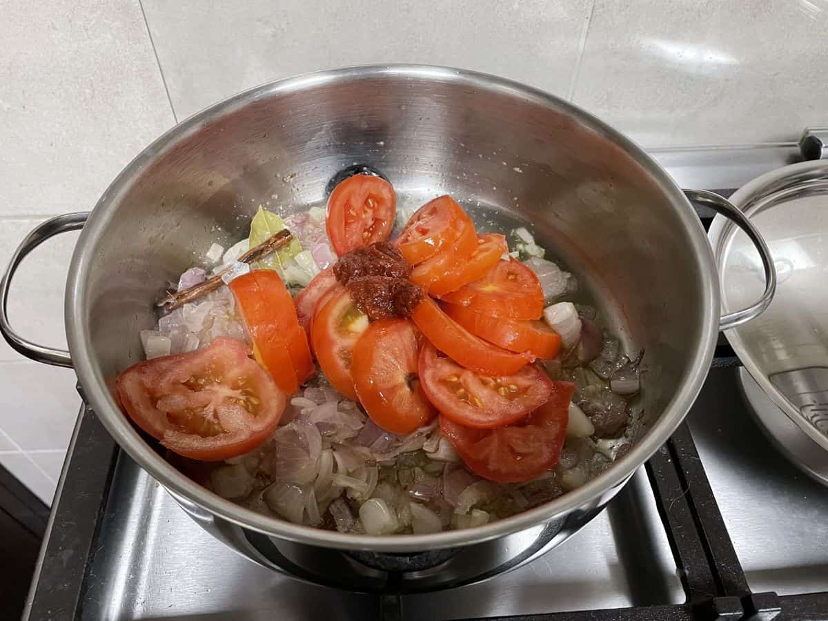 tomato roundels and tomato paste in sauted onions.