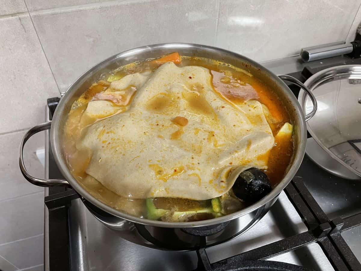 The thin sheet of dough dunked into the stew.