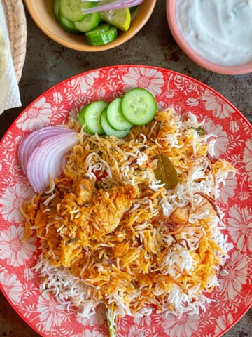 A plate of served chicken tikka biryani