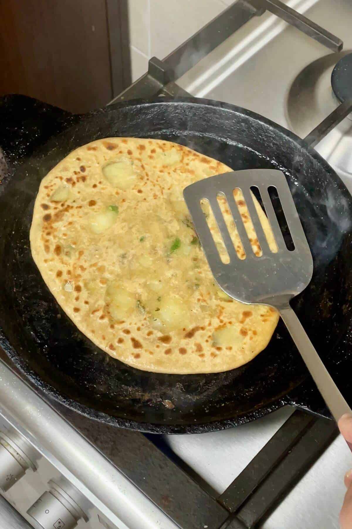 Cooking aloo paratha