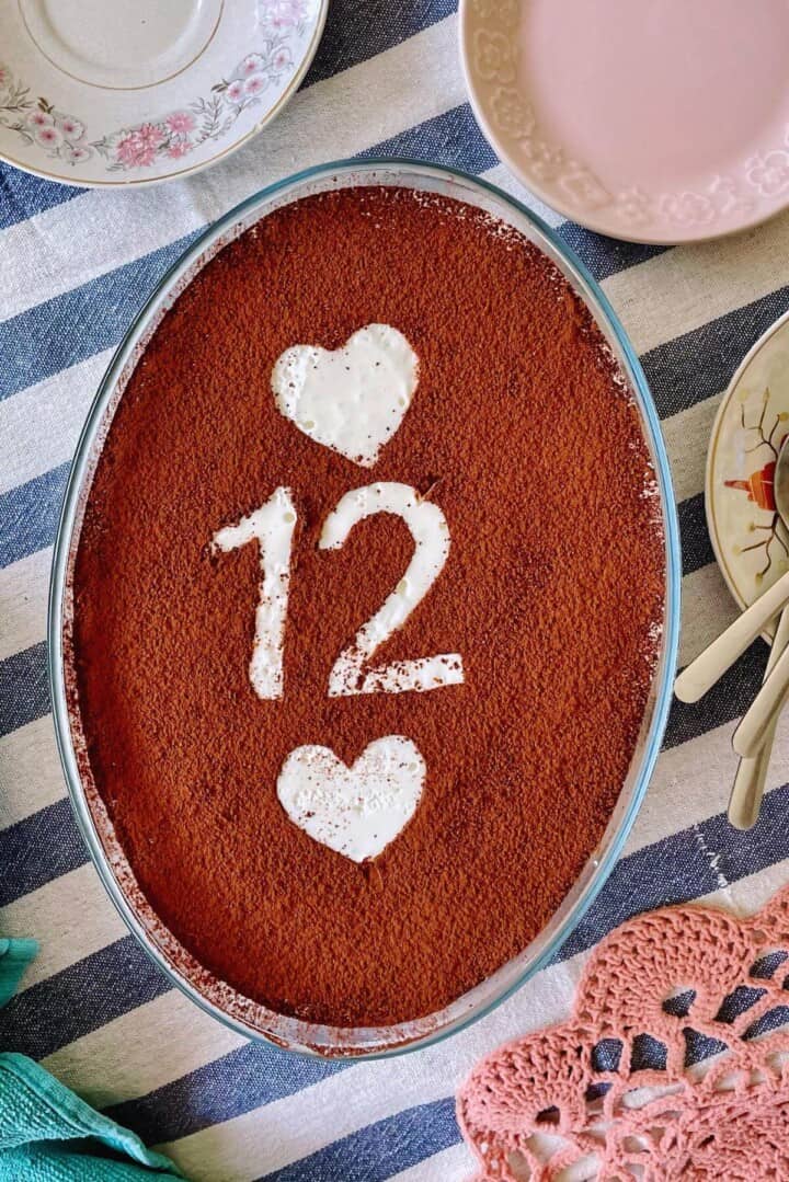 A chilled tiramisu with the number twelve on it.