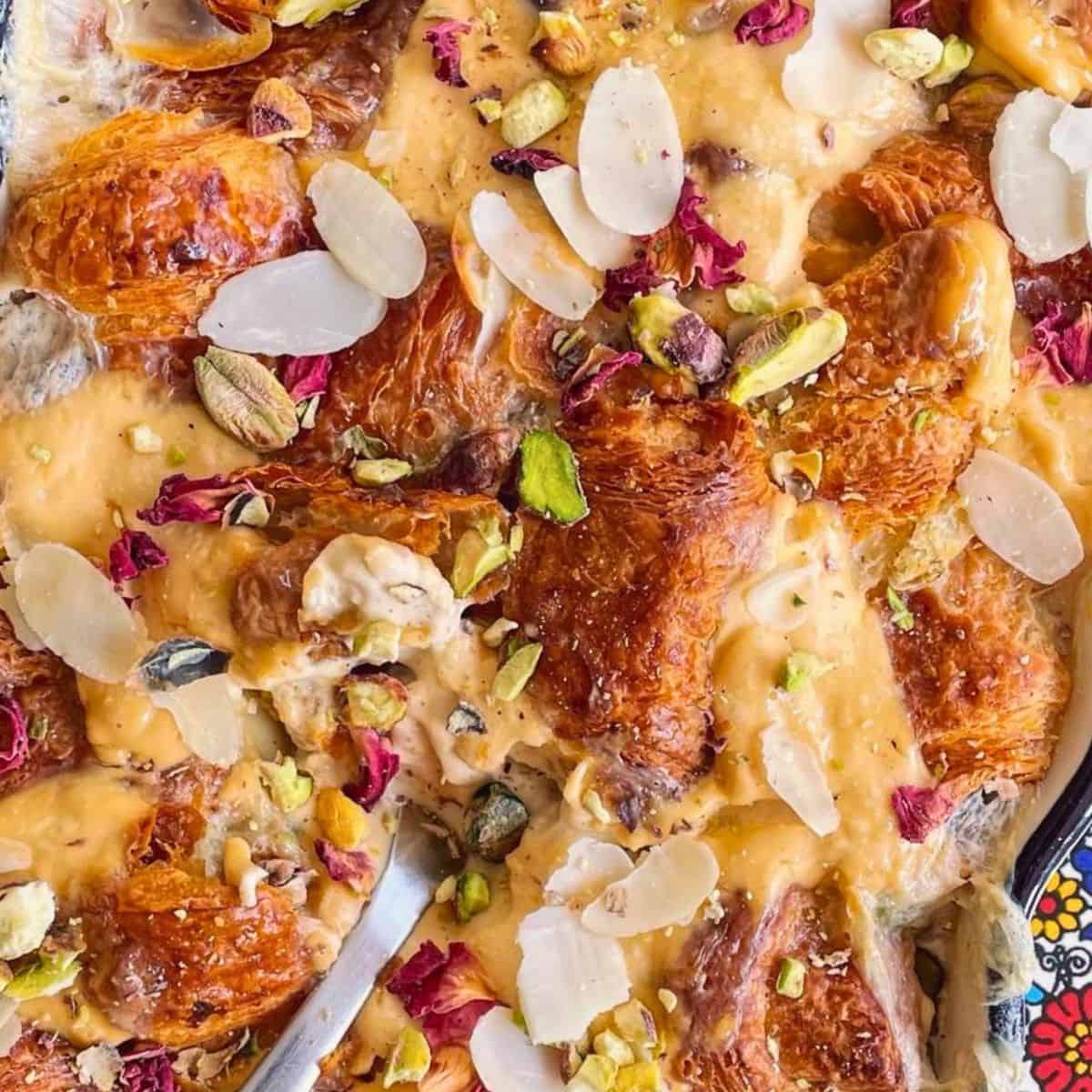 A close up of the Om Ali dish with the spoon.