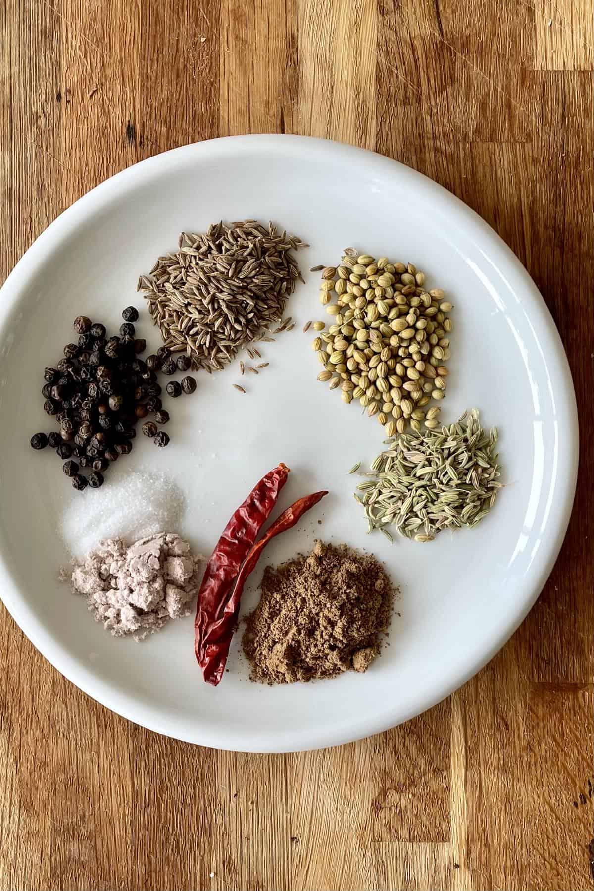 chaat masala ingredients of whole spices and salt portioned and plated