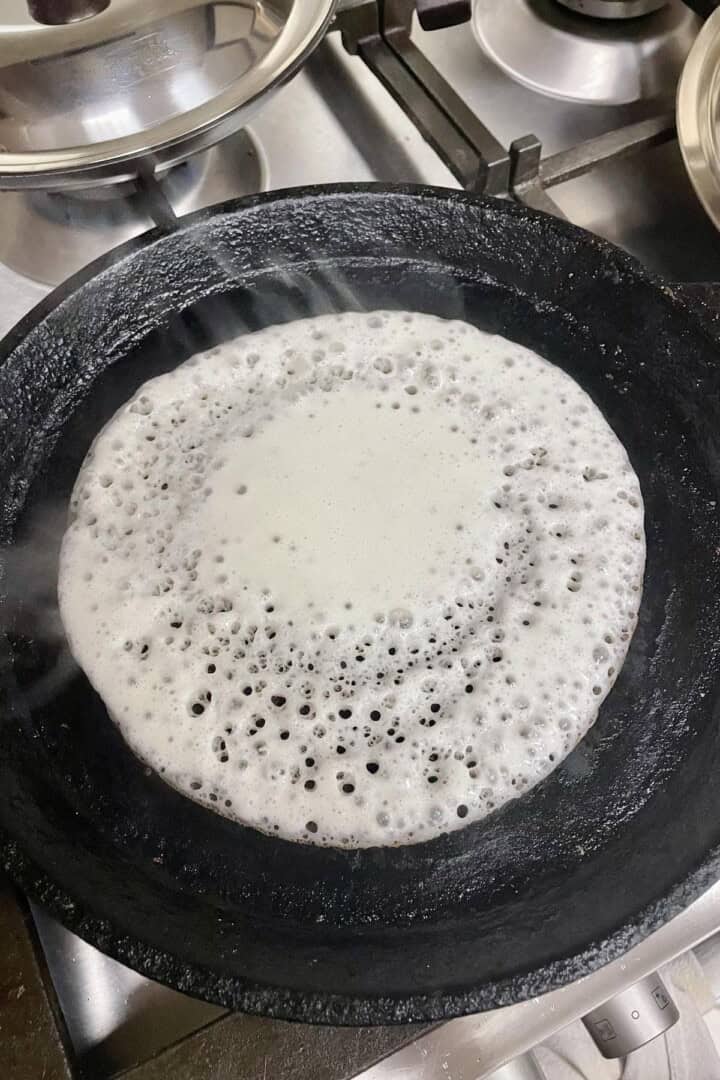 appam made on a flat cast iron pan. 