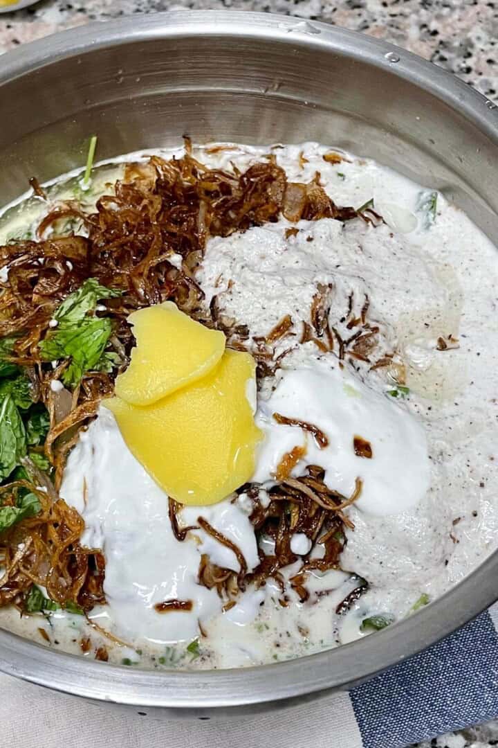 A bowl of chicken with all the marination ingredients added.