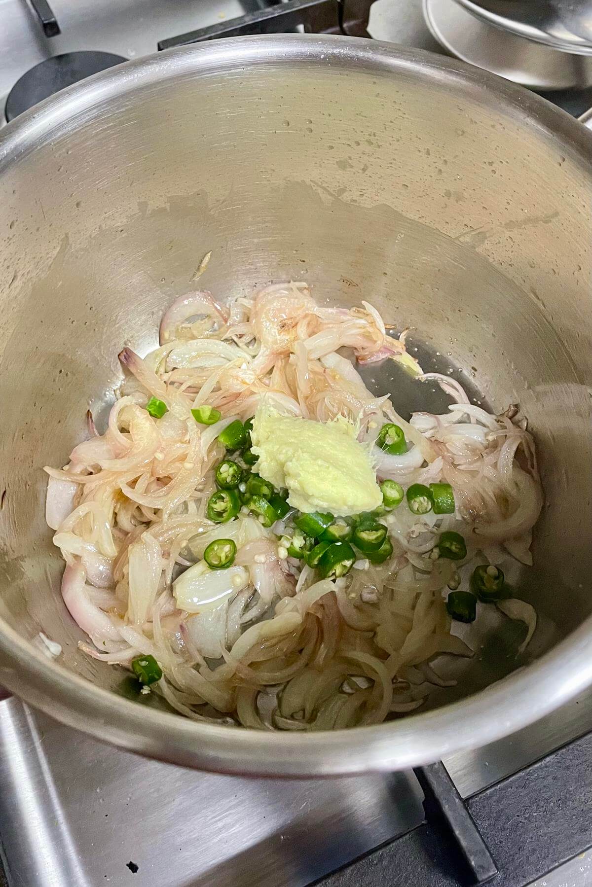 Sauteing aromatics with sliced onions. 