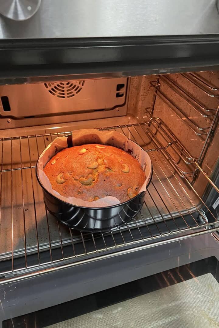 Kerala plum cake being baked in an oven on level 2 rack.