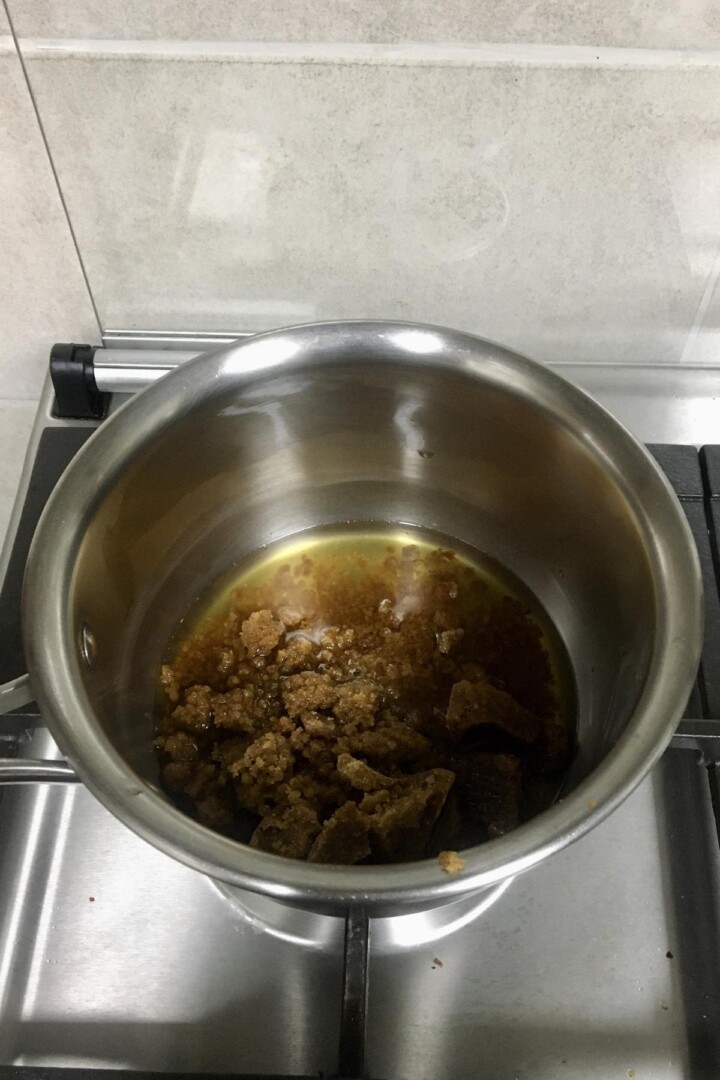 Jaggery and water in a saucepot.