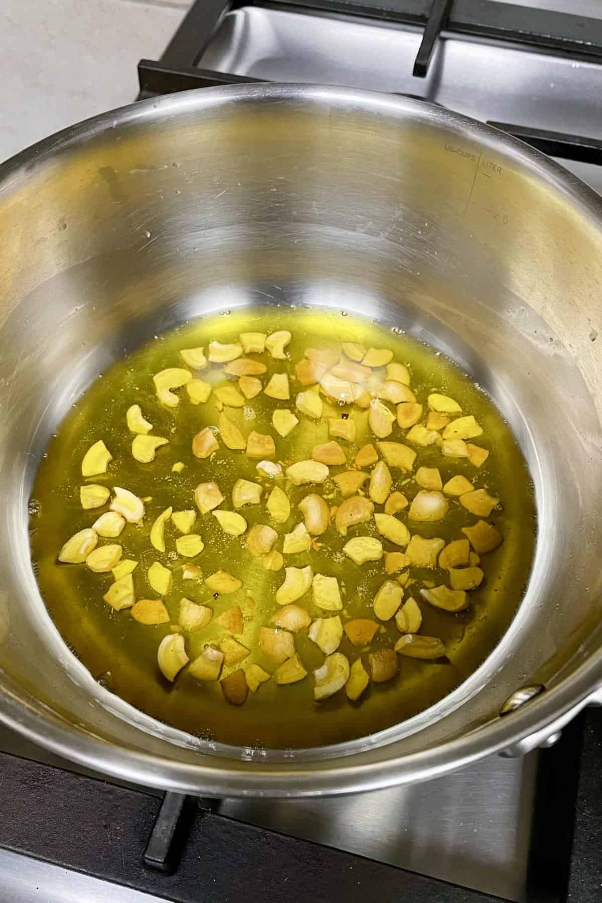 Chopped cashews frying in ghee.