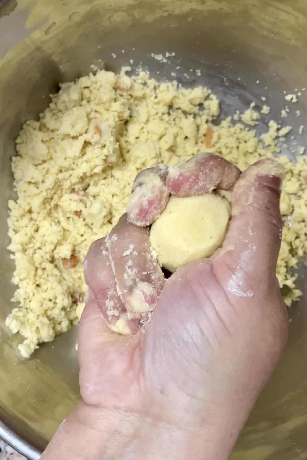 Shaping the rava laddu mixture into balls.
