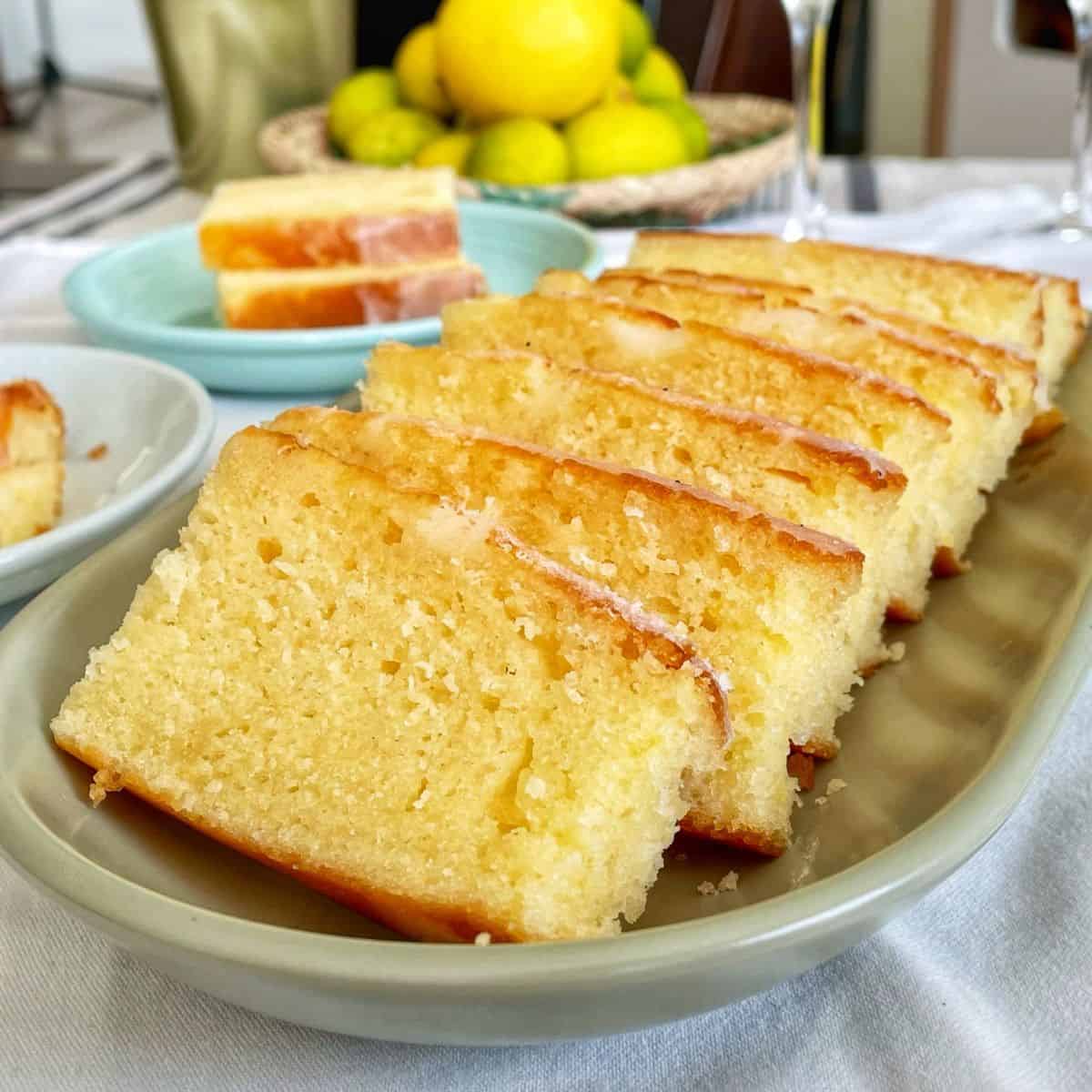 Slices of French lemon yoghurt cake in a oval dish.
