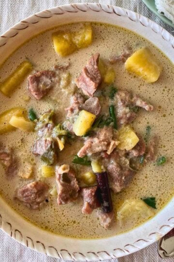 A bowl of kerala style mutton stew with potatoes.