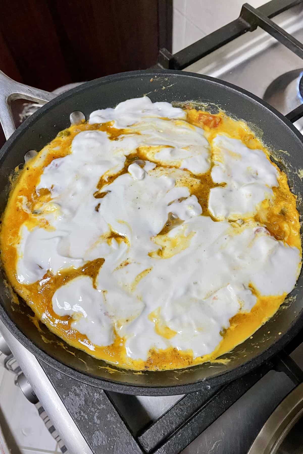 cream cheese spread over the scrambled eggs.