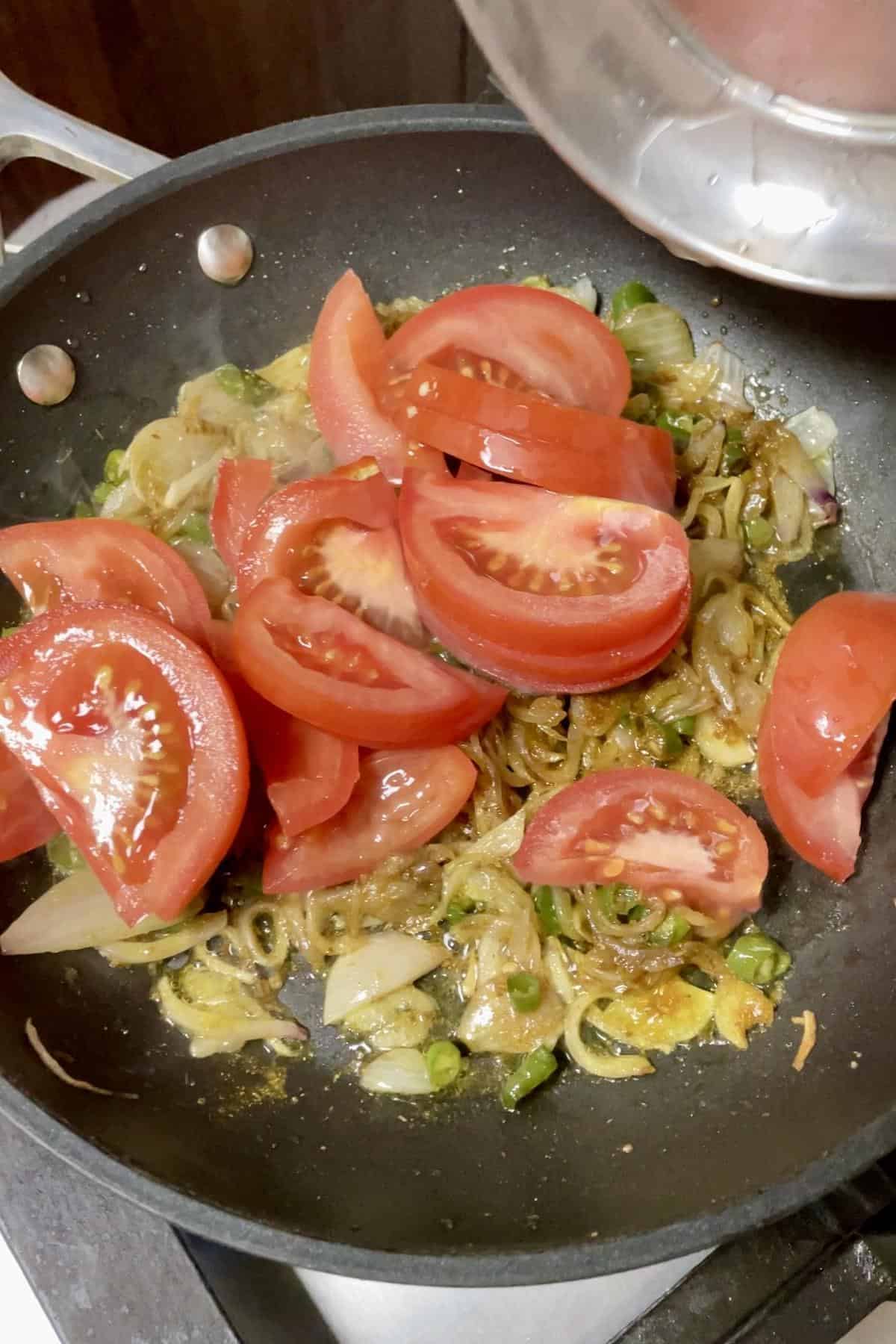 Chopped tomatoes on sauted onions.