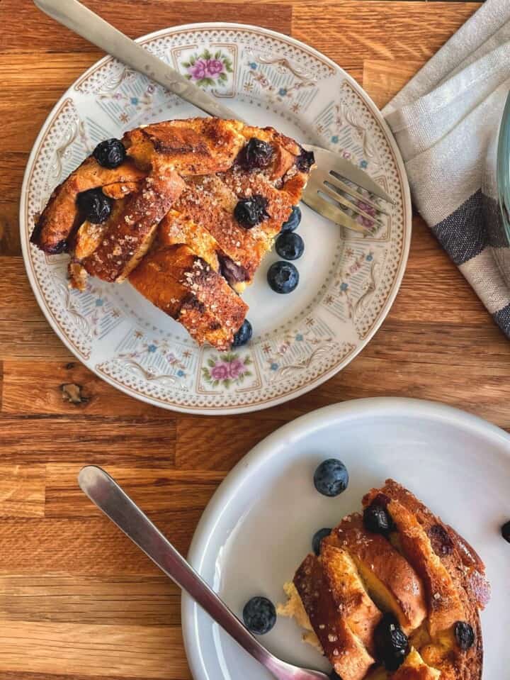 A small portions of French Toast Casserole with sliced bread served in two plates