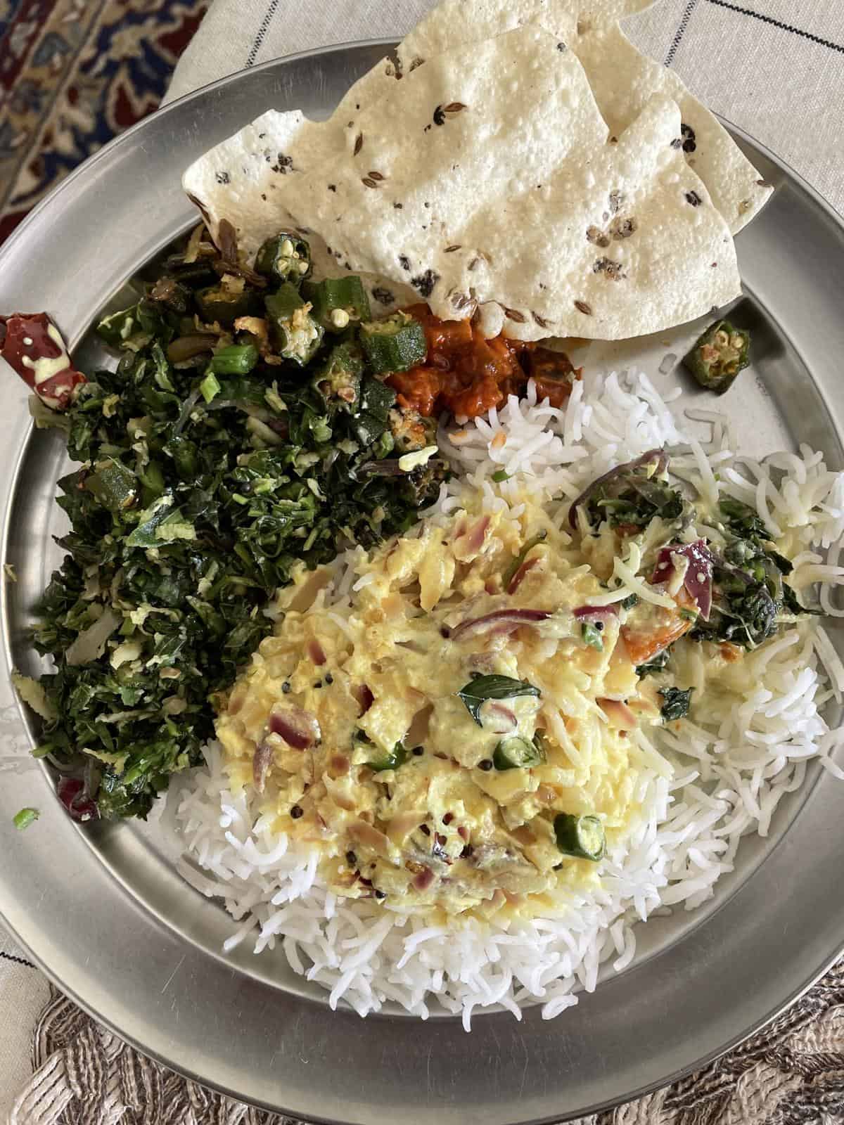 A plate of rice, moru curry, cheera, pappadan and okra fry.