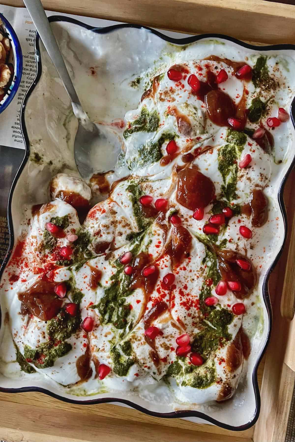 A platter of dahi baray garnished and ready to serve.