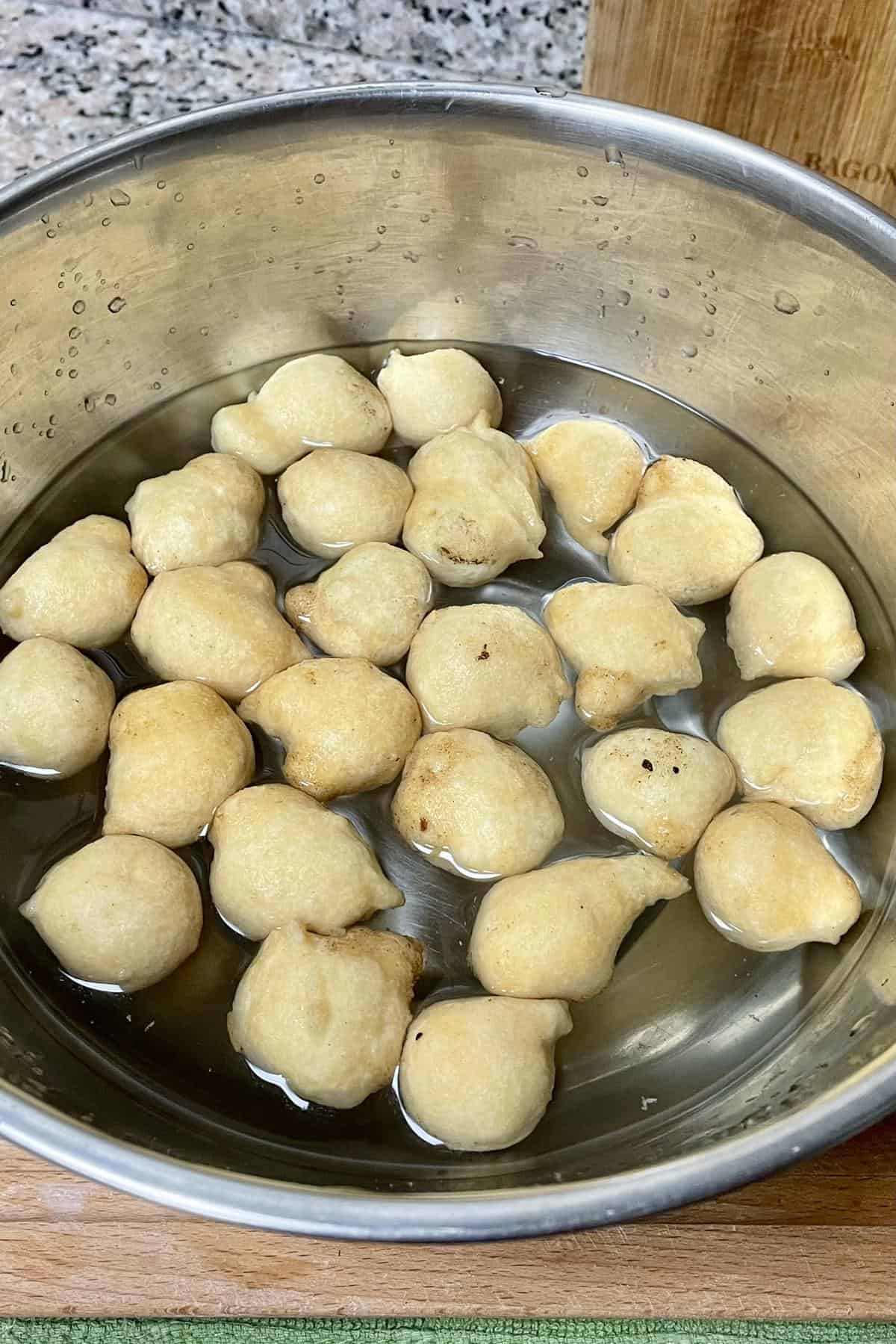 Lentil fritters soaking in lukewarm water.