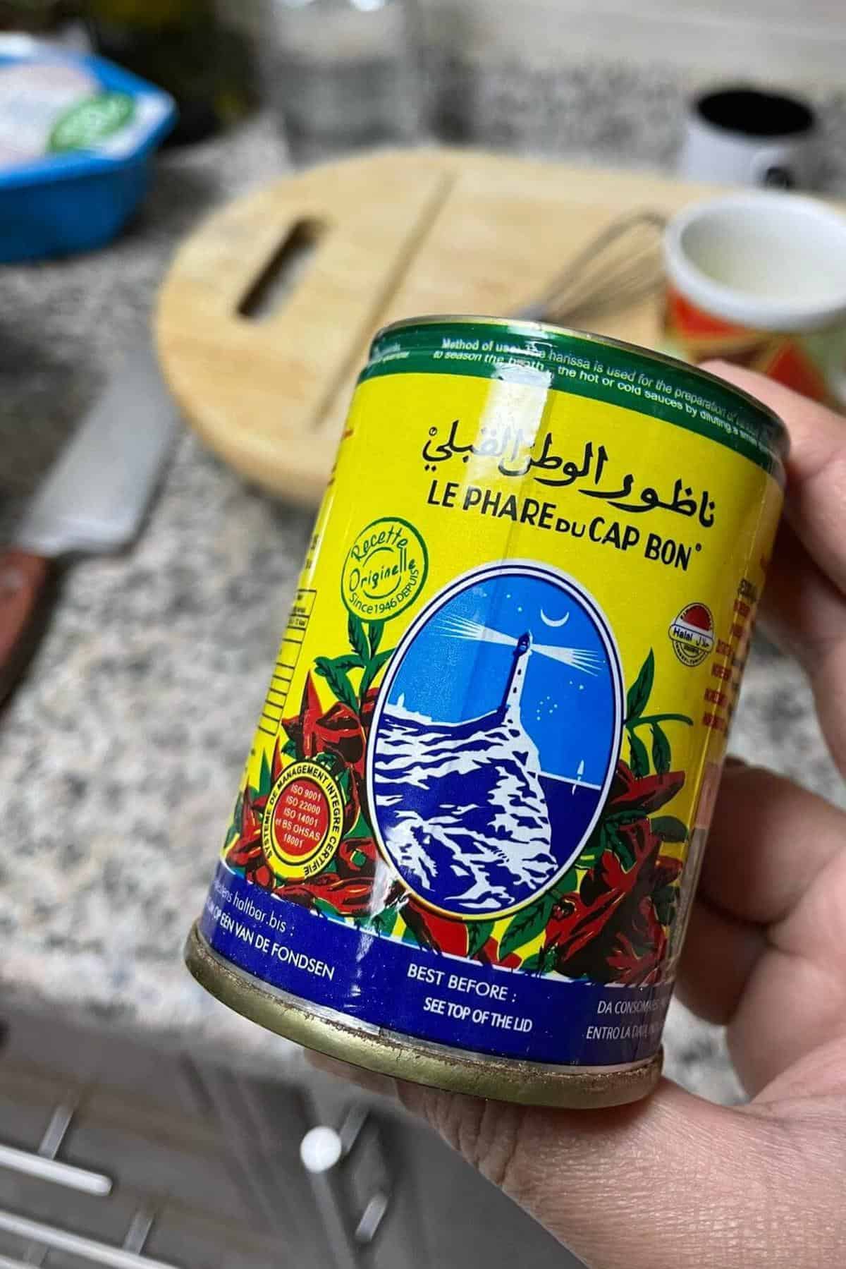 A can of Harissa held in my hand. 