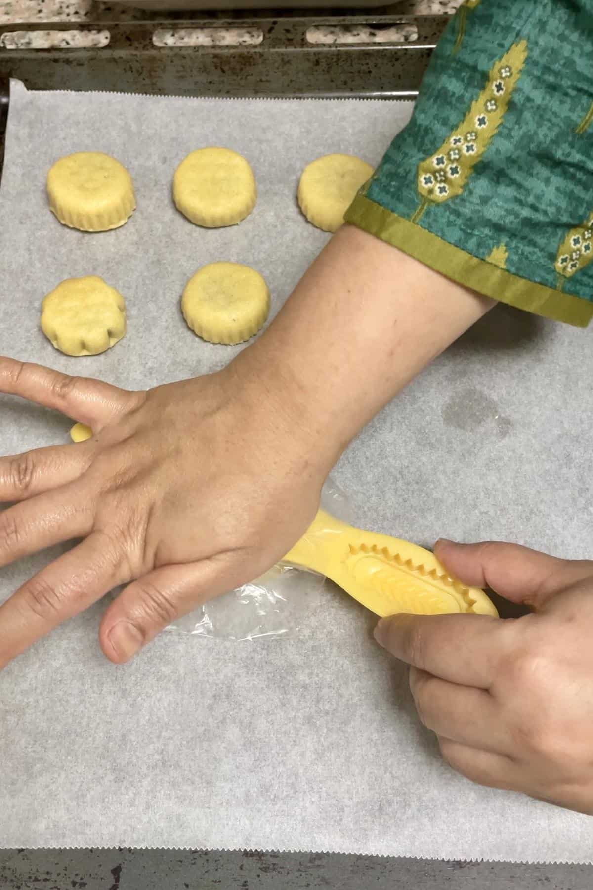 Pressing the stuffed cooking into the mould.