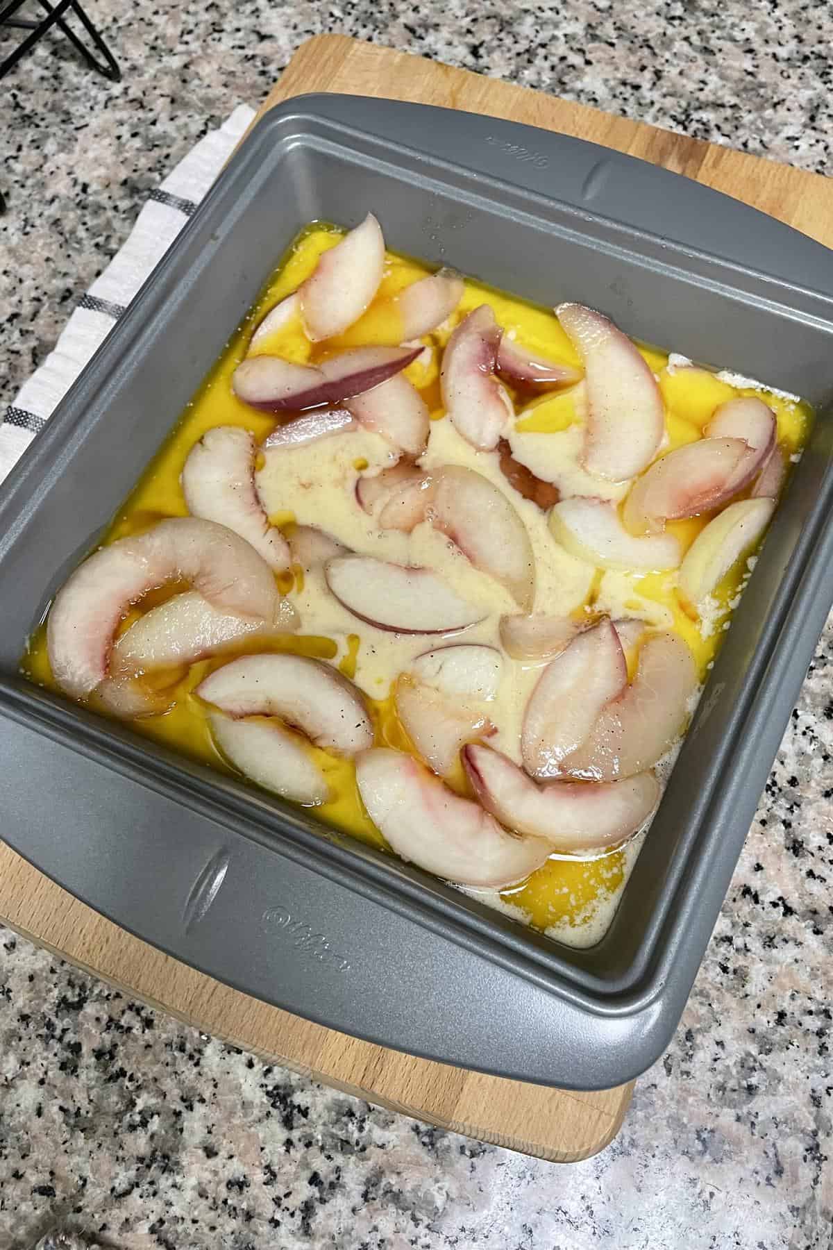 Assembled nectarine cobbled in a baking dish ready to go into the oven.