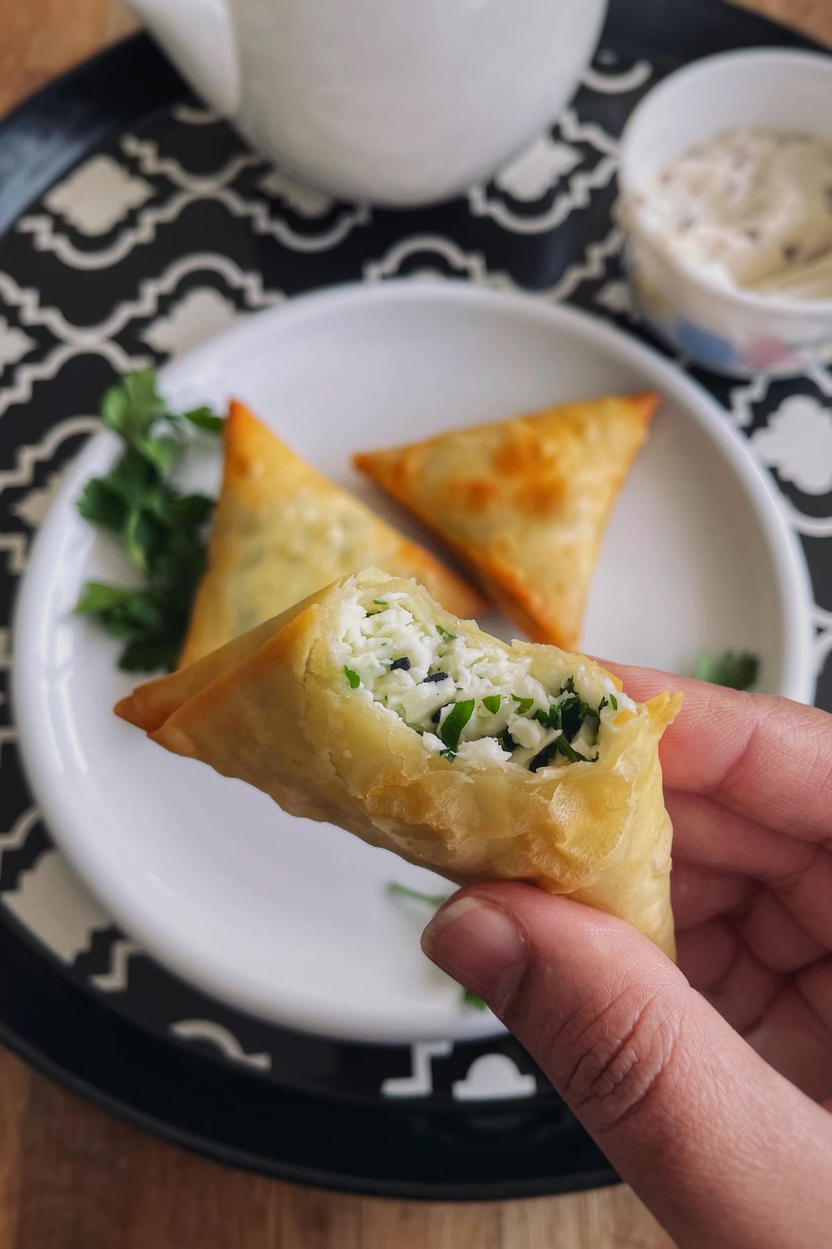 Half bitten cheese samosa