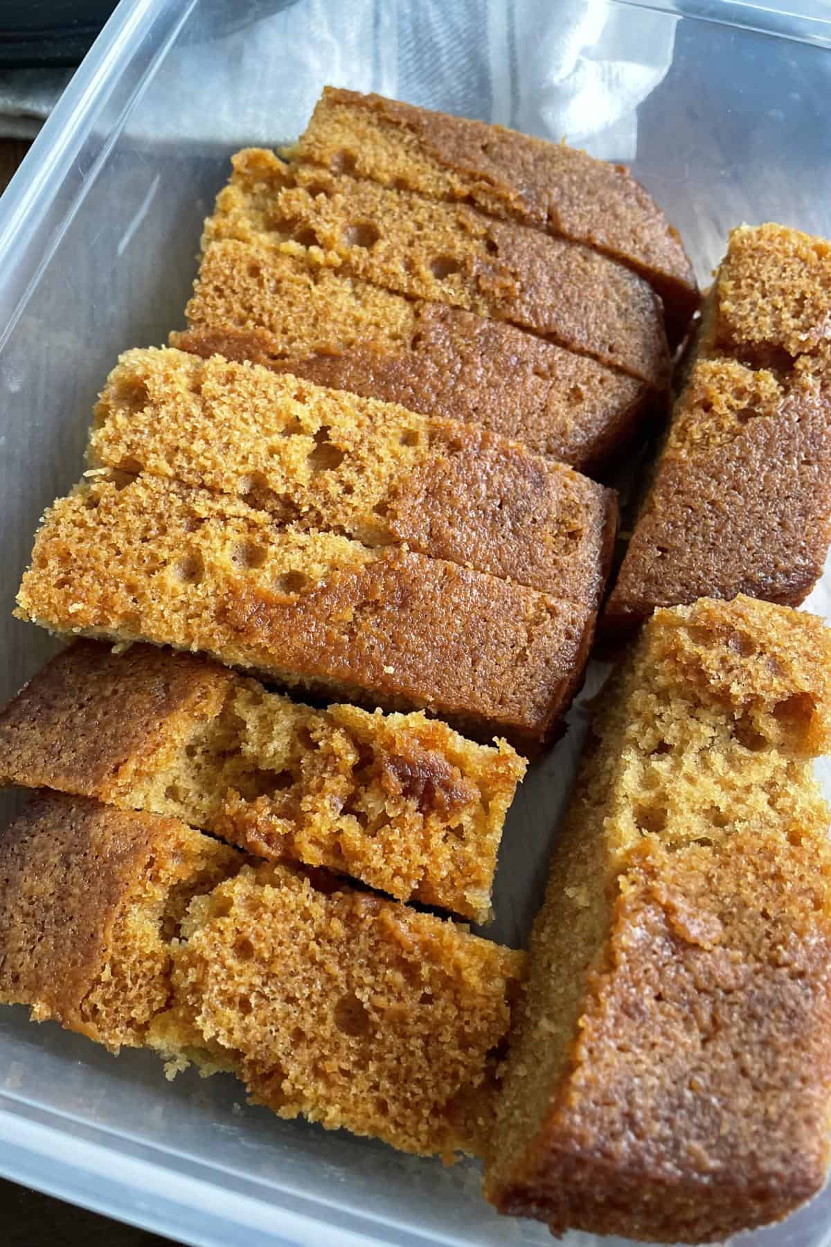 A box of sliced caramel syrup cake. 